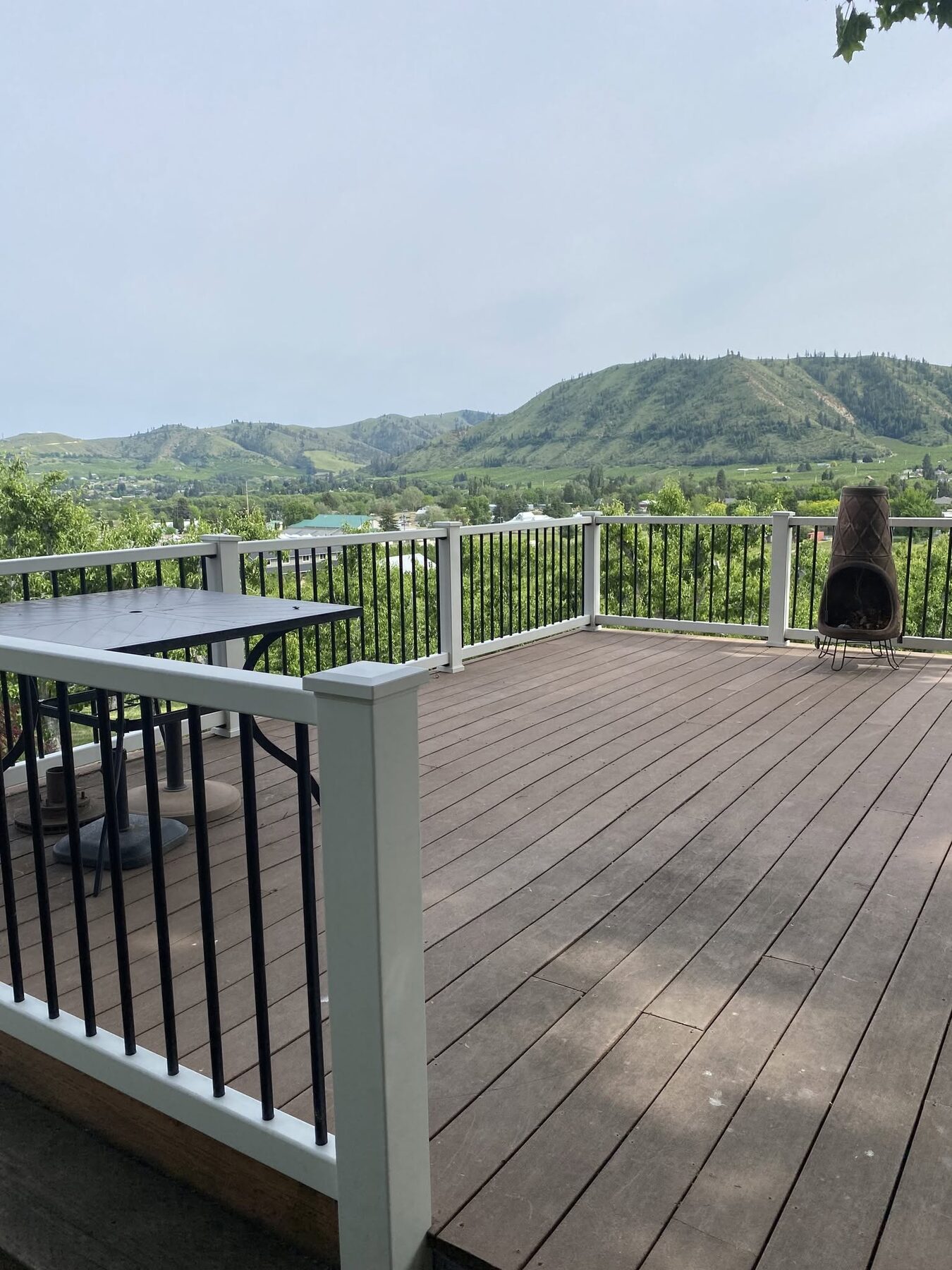 Composite view deck with white aluminum railing and black balusters