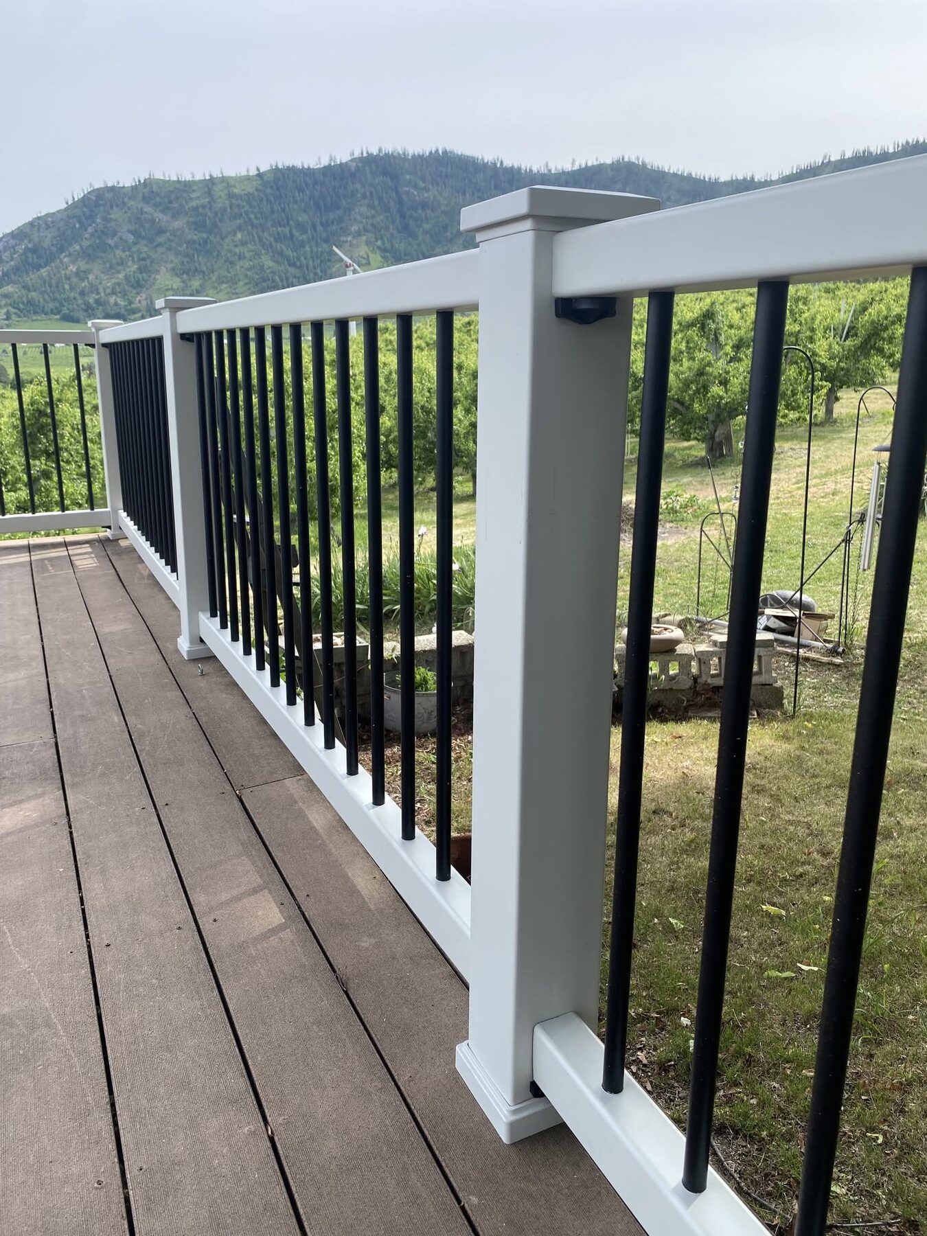 Composite view deck with white aluminum railing and black balusters