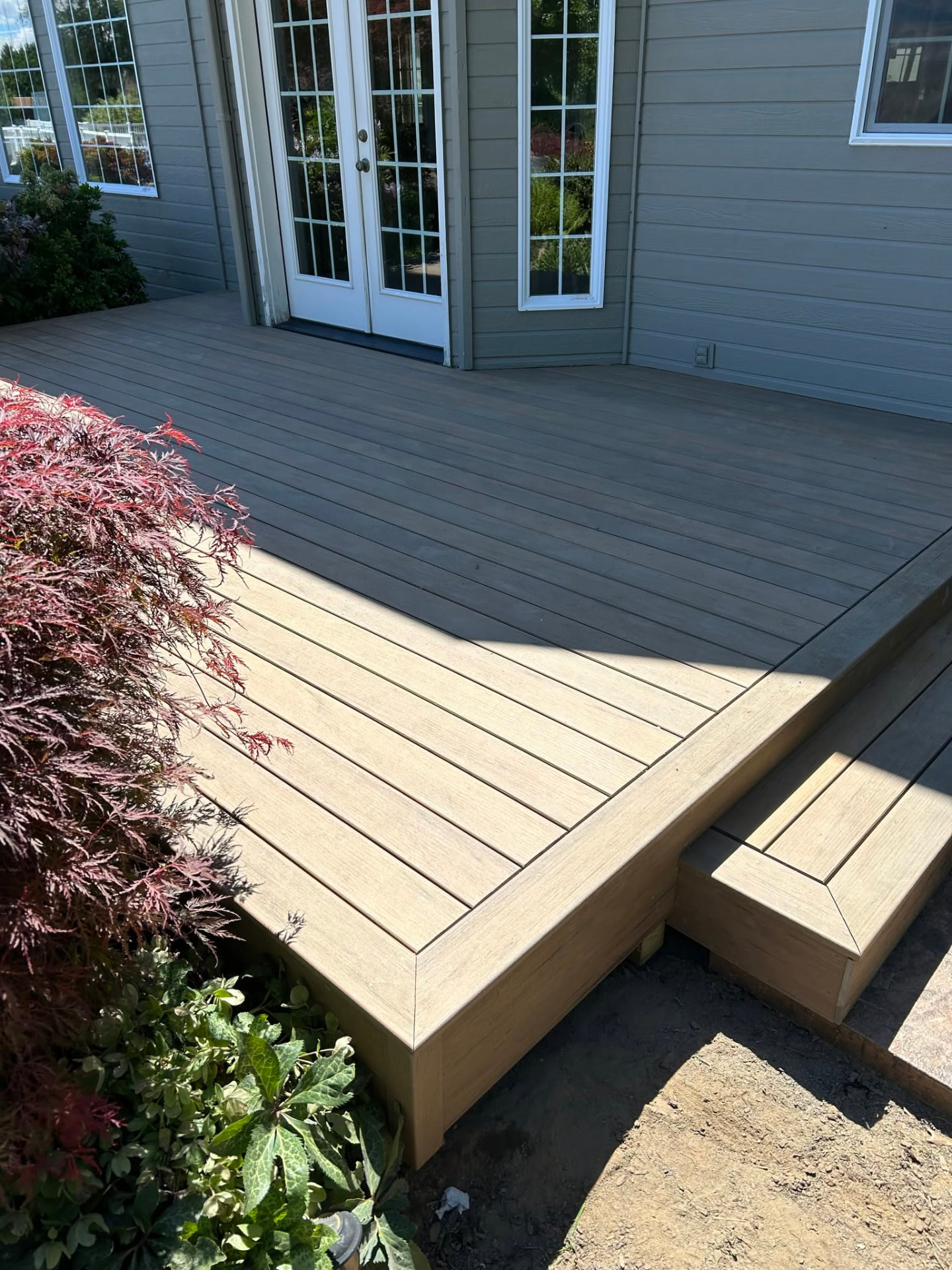 Composite deck with wide steps and landscaping built in Wenatchee, WA