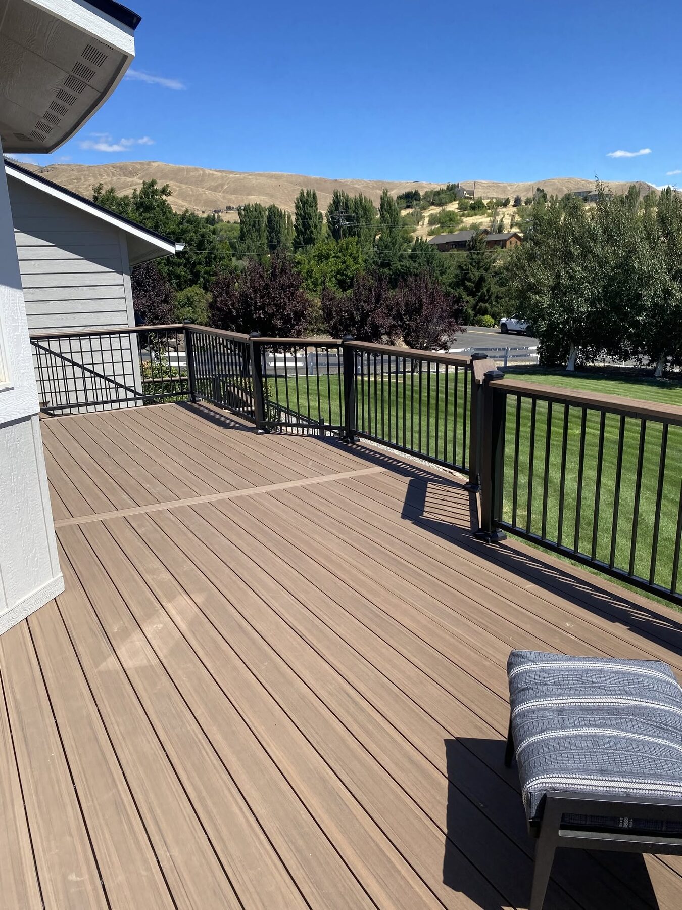 Composite deck with black aluminum railing and valley views