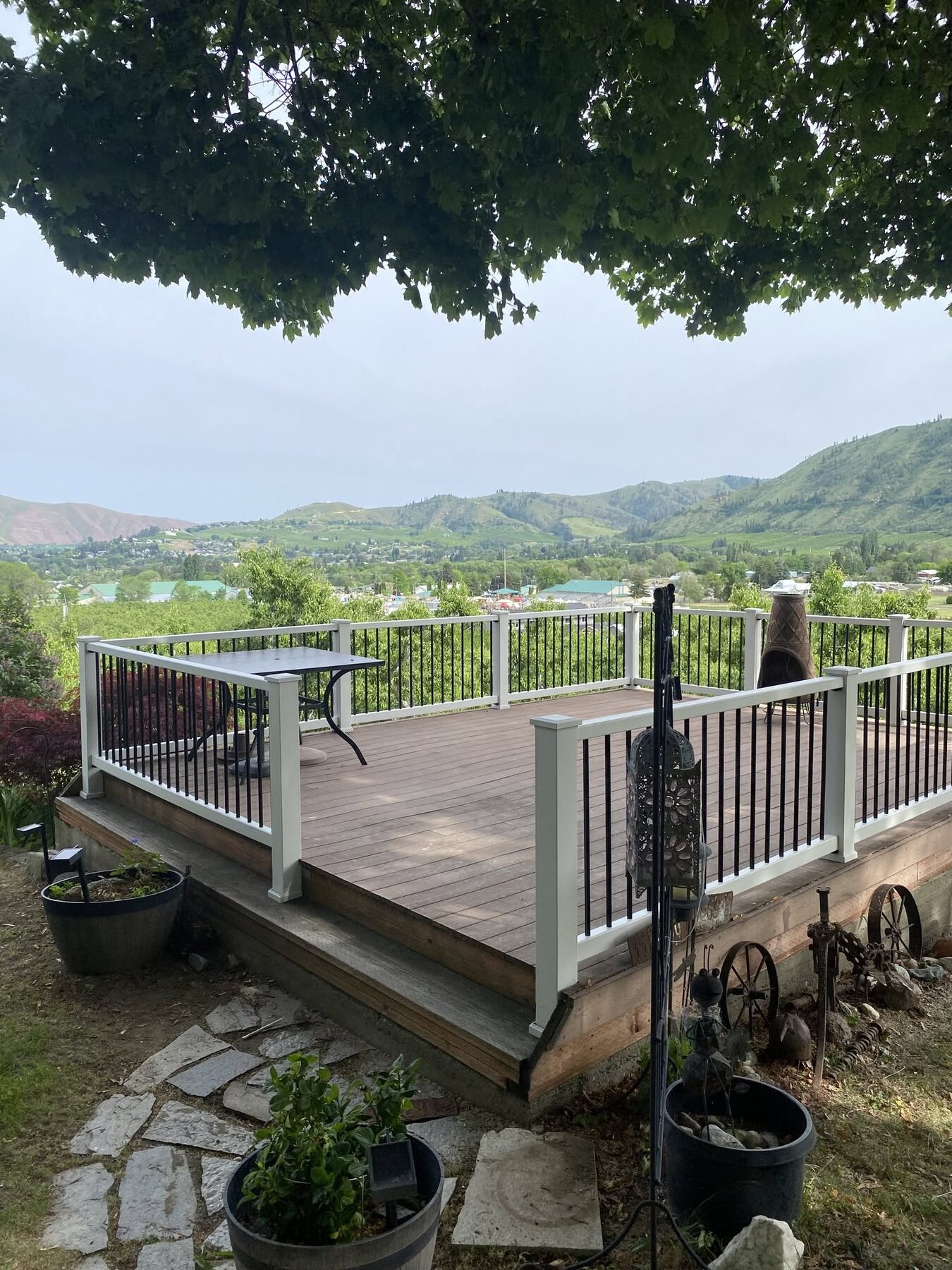 Composite view deck with white aluminum railing and black balusters