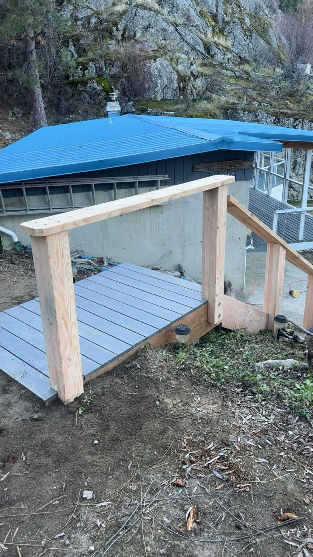 Custom wooden footbridge built for a backyard crossing