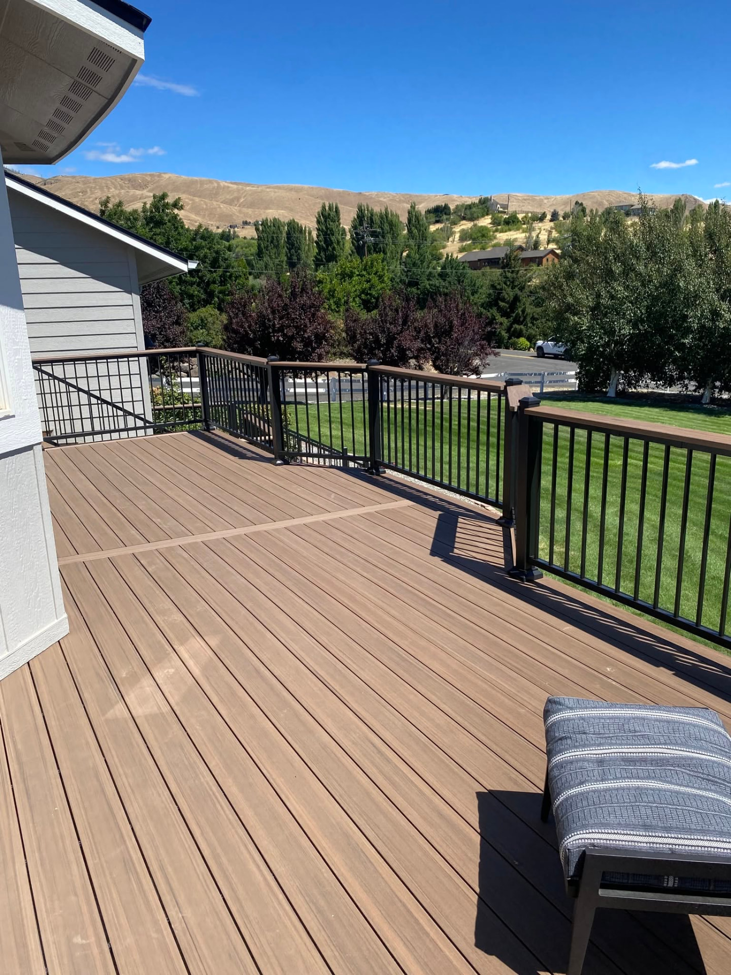 Composite deck with black railing and stairs built in Wenatchee, WA — view 1